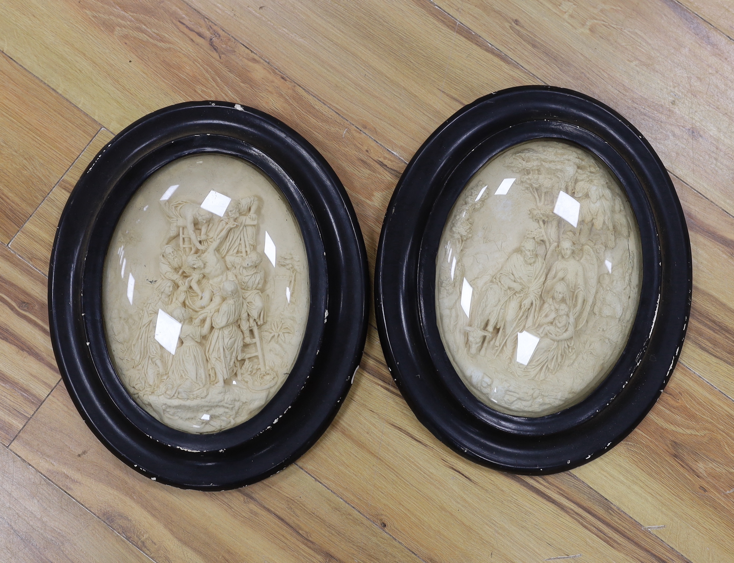 A pair of 19th century religious oval plaques, 29cm high not including frame
